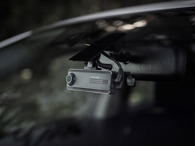 Dash cam with parking mode monitoring parked vehicle